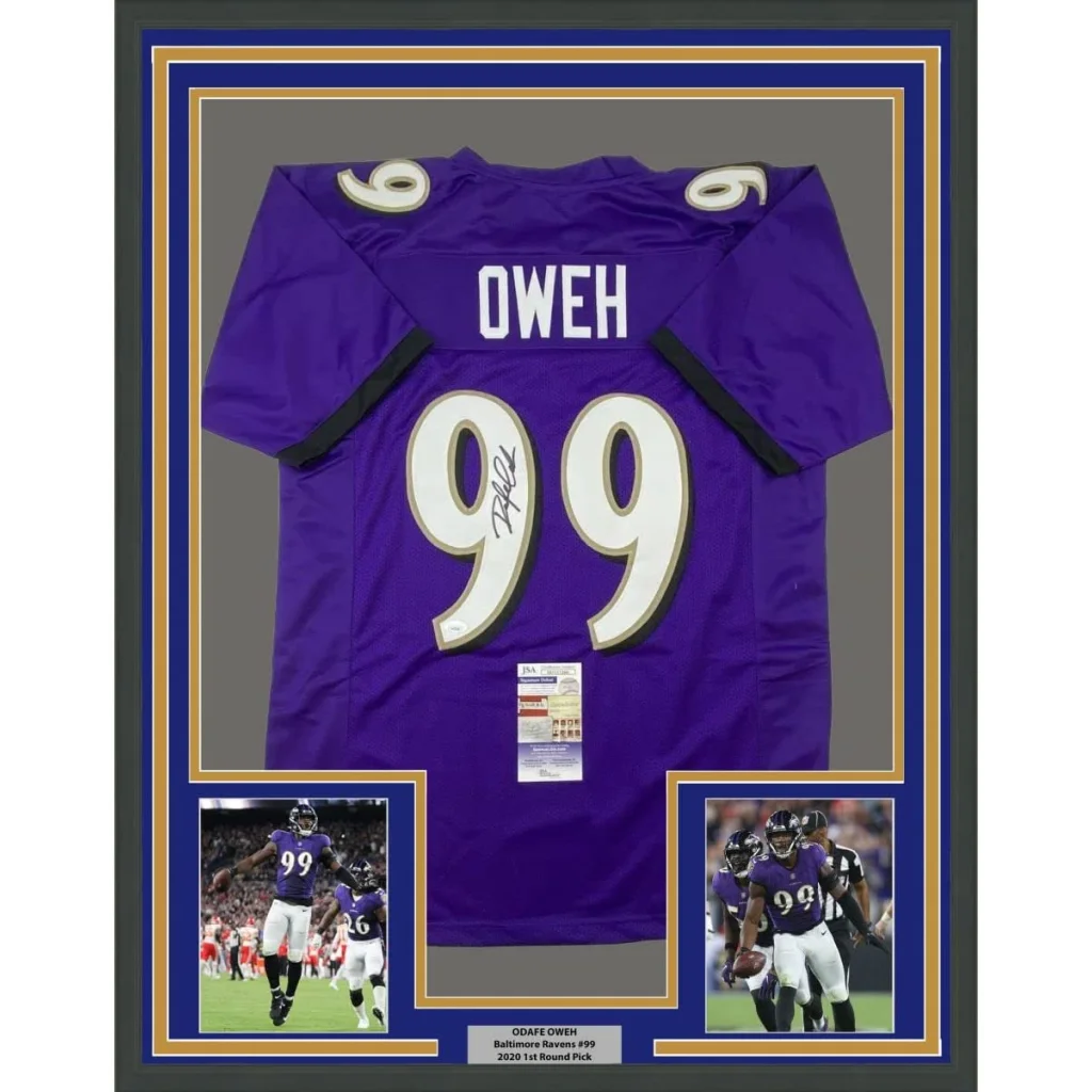 Framed signed purple Baltimore Ravens jersey with player photos on display
