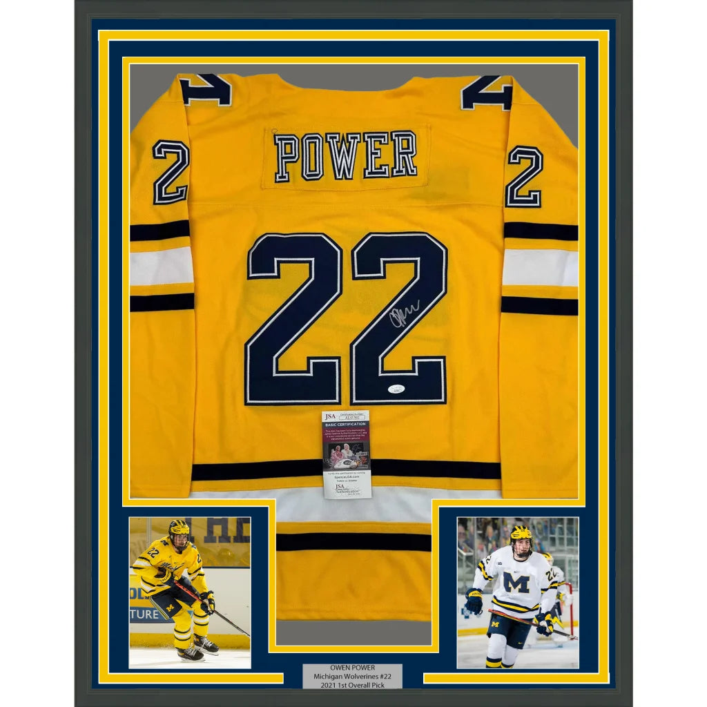 Framed autographed yellow Michigan Wolverines Owen Power #22 hockey jersey with player photos