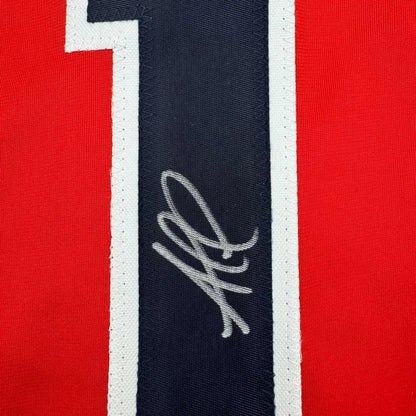 Framed autographed Ozzie Albies Atlanta Braves jersey with white embroidered signature on navy stripe