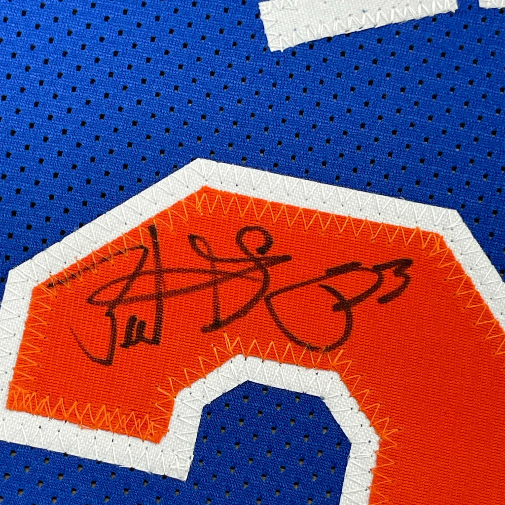 Blue Patrick Ewing Knicks jersey with orange number 2 and black ink signature in frame