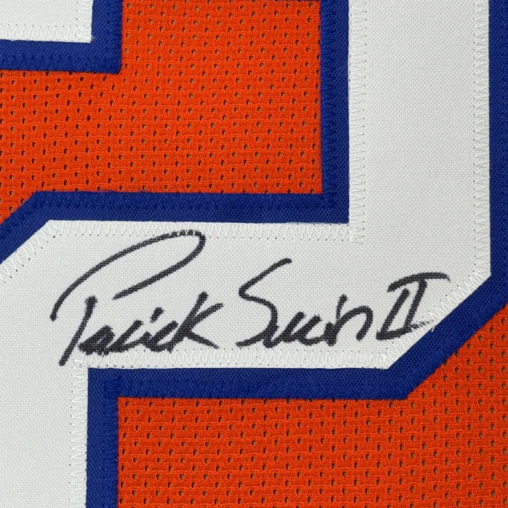 Framed autographed orange and white mesh football jersey with blue trim signed by Patrick Surtain II with JSA COA