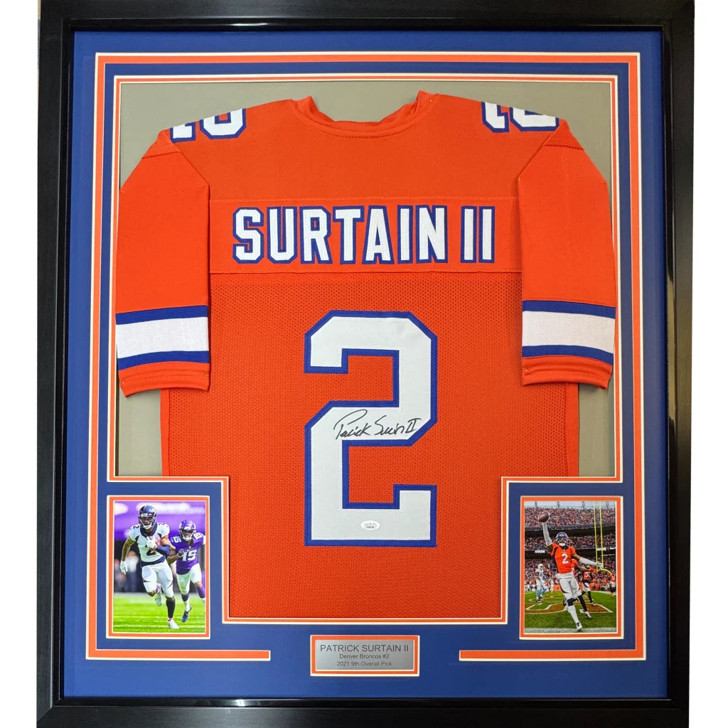 Back of framed autographed denver retro orange football jersey with white blue trim featuring surtain ii number 2
