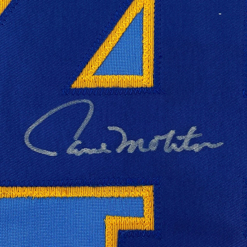 Blue fabric with a gold-bordered blue triangle and a silver autograph on a Paul Molitor signed Brewers jersey