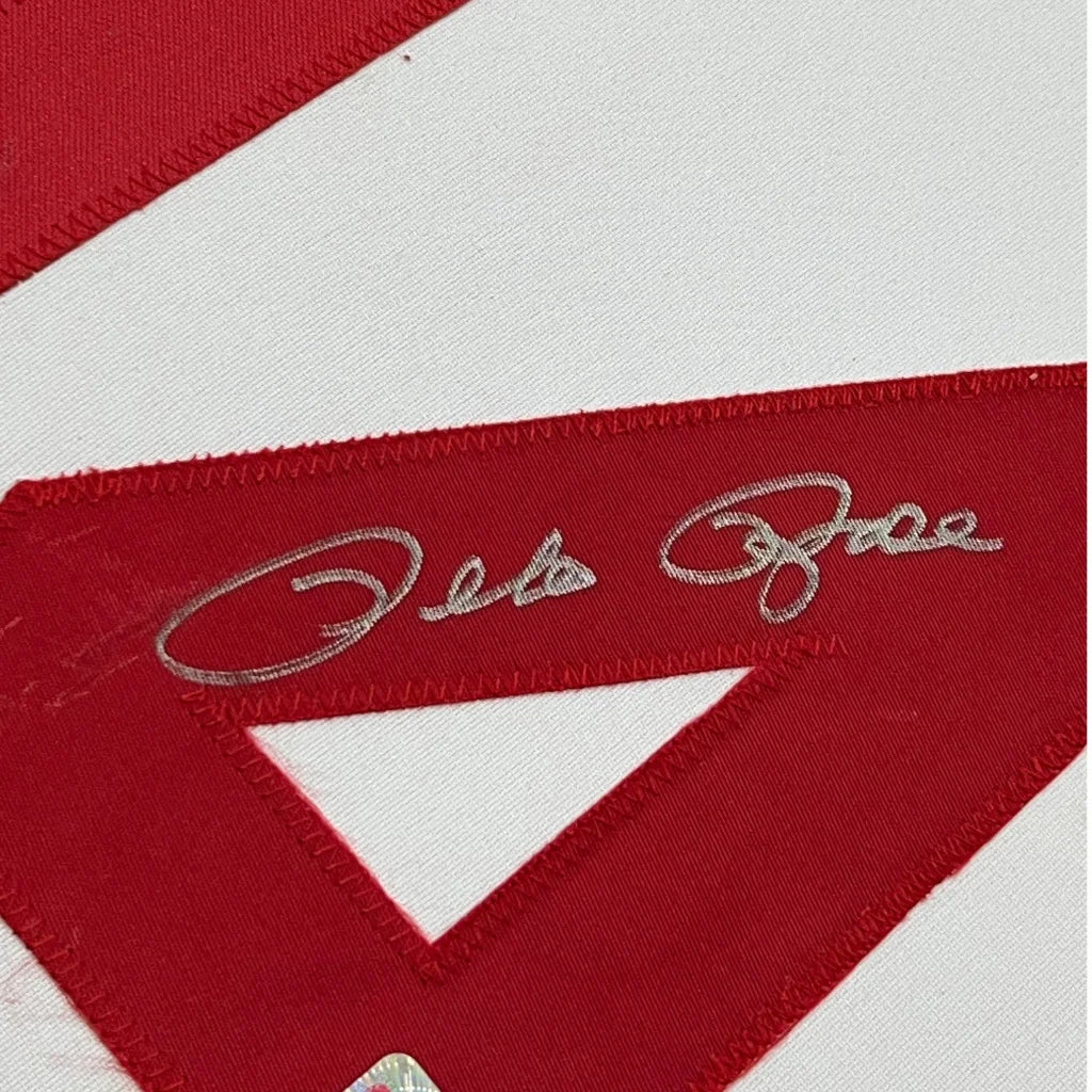 Embroidered red and white fabric with metallic silver signature from Pete Rose Jersey