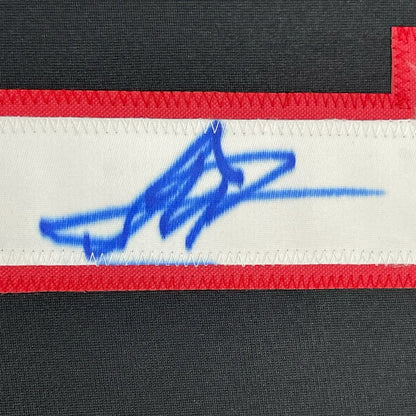 Blue autograph on white and red Yan Fighter Jersey in a 35x39 frame ready to hang