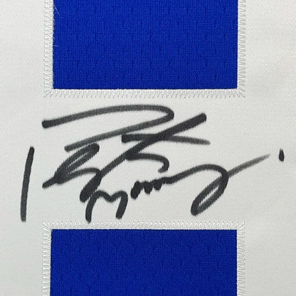 Blue and white Peyton Manning Colts jersey with black marker autograph in frame