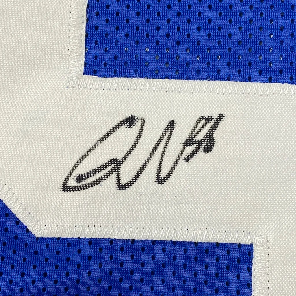 Blue Colts sports jersey with white number and black autograph in a photos frame