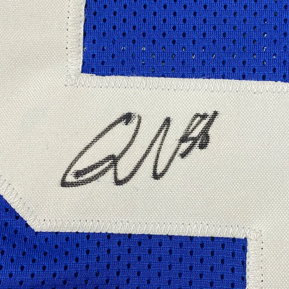 Blue Colts sports jersey with white number and black autograph in a photos frame
