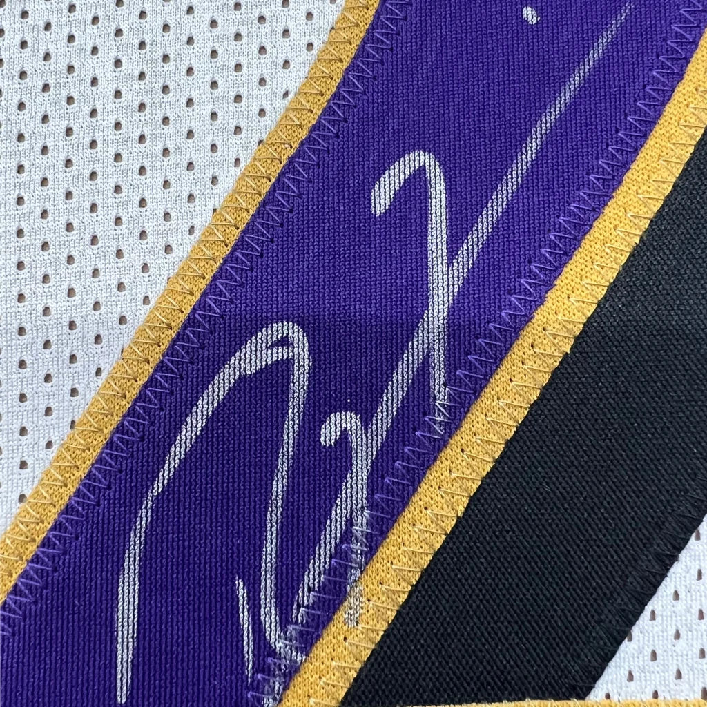 Autographed purple and gold Ravens jersey with Ray Lewis signature and player photos