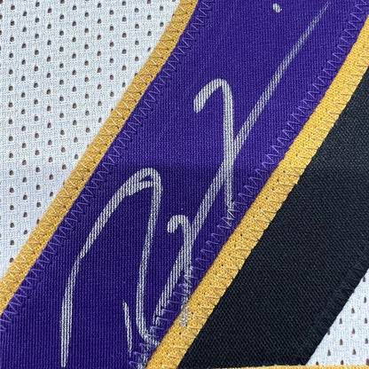 Autographed purple and gold Ravens jersey with Ray Lewis signature and player photos