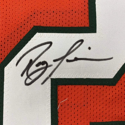 A black ink signature on a white mesh Miami orange college football jersey with orange and green accents