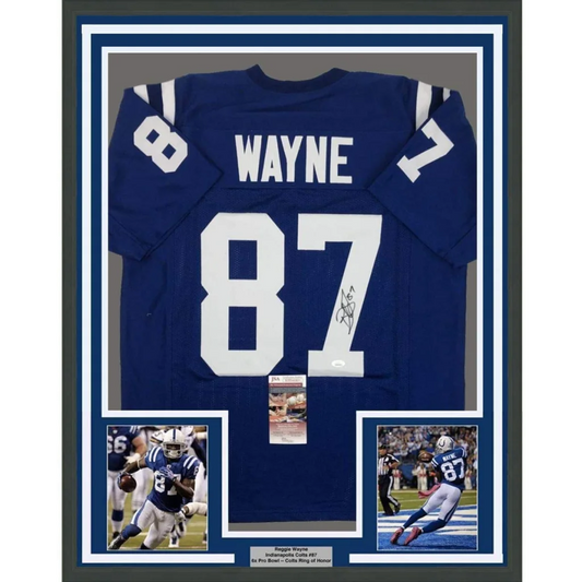 Back side of a framed autographed blue indianapolis colts football jersey with white number 87 and name wayne