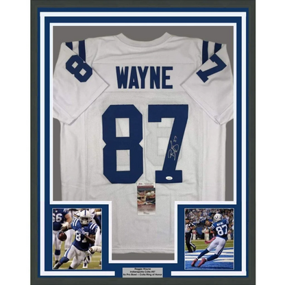 Back of a framed autographed white indianapolis colts football jersey with blue 87 and wayne signed in black ink
