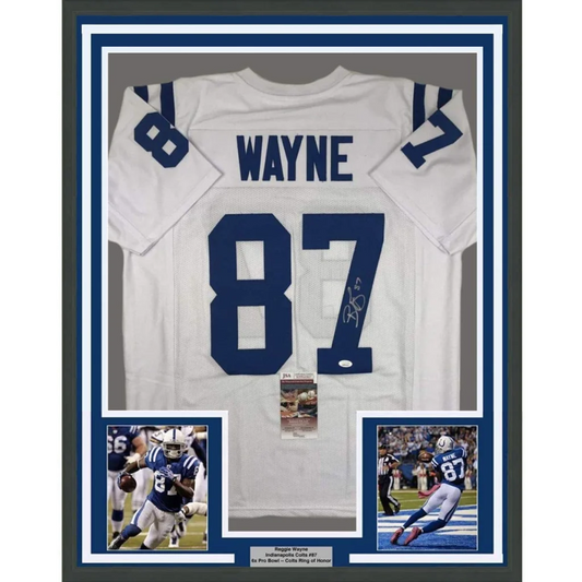 Back of a framed autographed white indianapolis colts football jersey with blue 87 and wayne signed in black ink