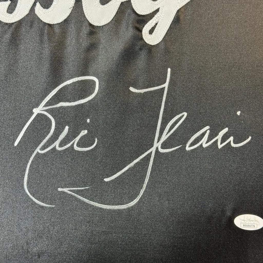 Black fabric with white embroidered signature from Ultimate Man Cave Ric Flair robe display