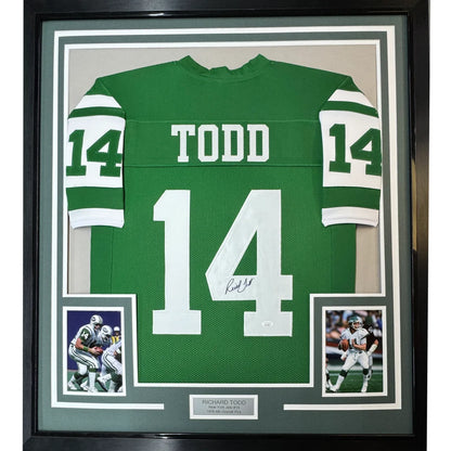 Framed autographed Richard Todd New York Jets jersey with team photos on display
