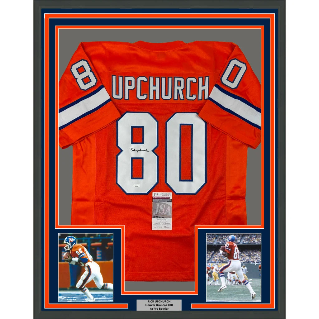 Autographed Denver Broncos jersey with player photos in a frame ready to hang