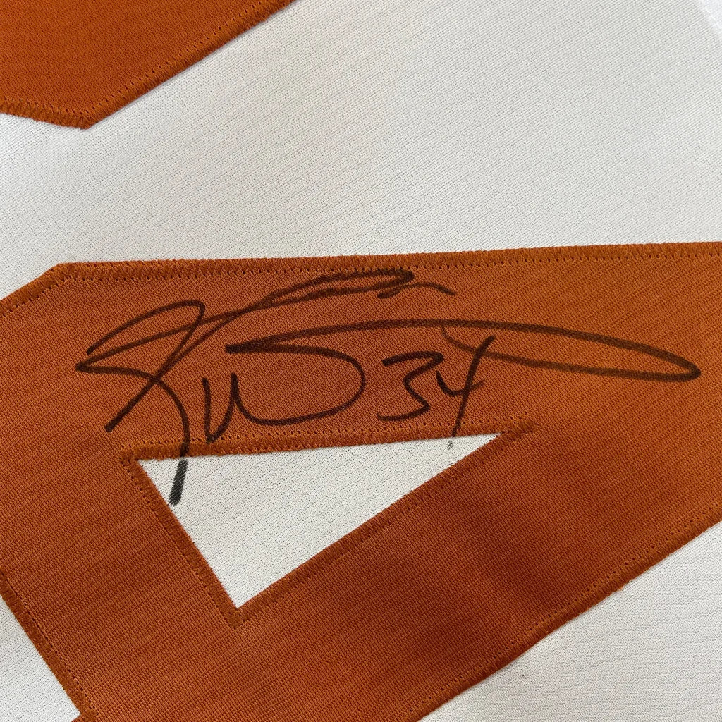 Close-up of Ricky Williams signed black ink on framed Texas white college jersey