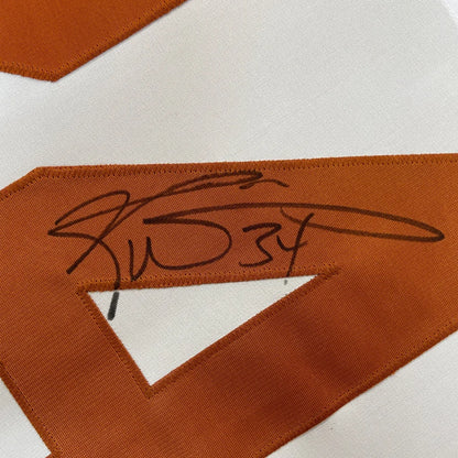 Close-up of Ricky Williams signed black ink on framed Texas white college jersey