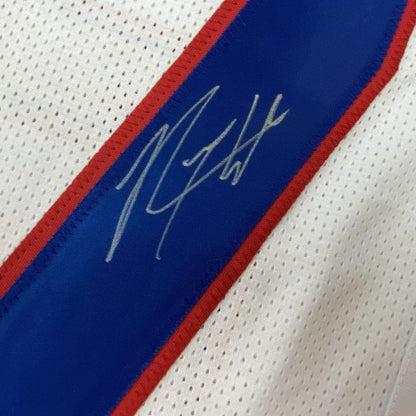 Autographed white Giants jersey with red and blue trim in a professionally framed display