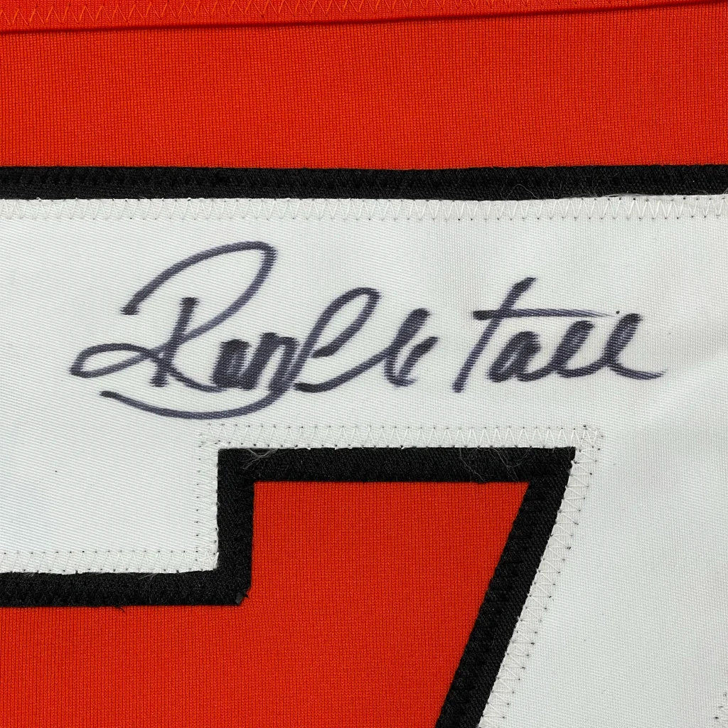 Orange and white sports jersey with black ink autograph, professionally framed for display