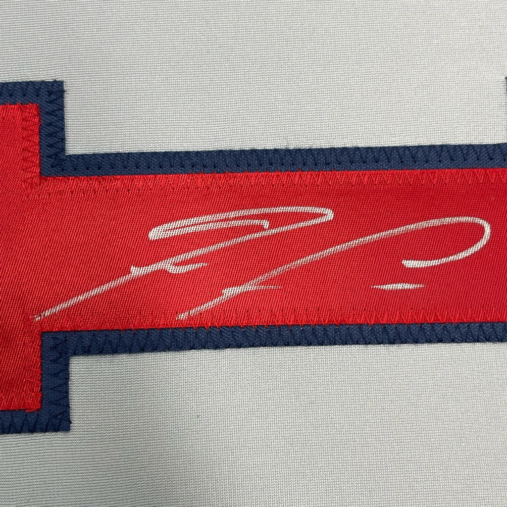 Framed autographed Ronald Acuna Jr. Atlanta Braves jersey with red and navy embroidered patch