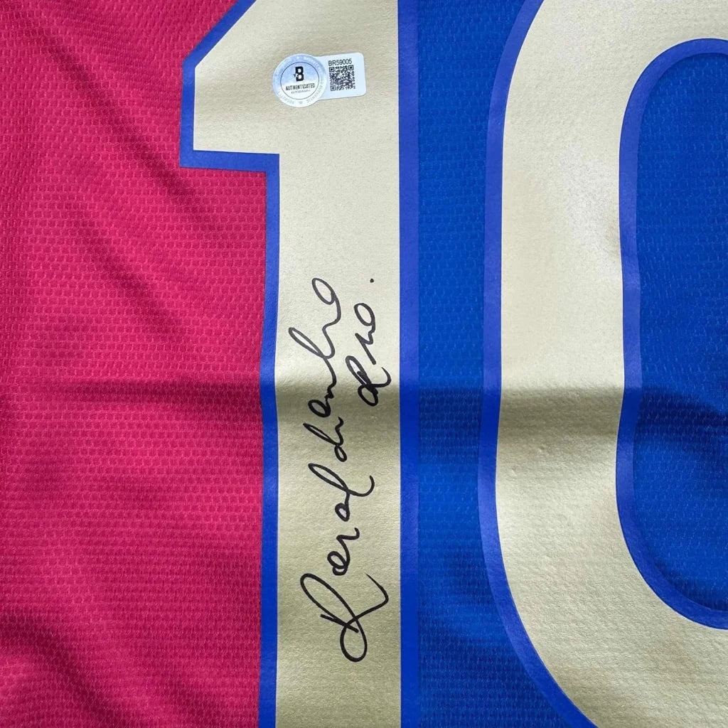 Signed Ronaldinho Barcelona Jersey with number 10 in a frame, perfect for fans