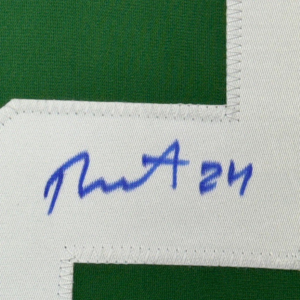 Green hockey jersey with white number and blue autograph, perfect for display
