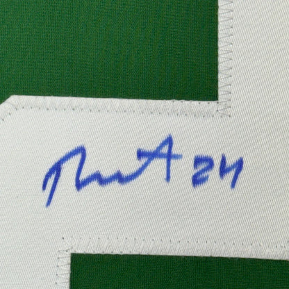 Green hockey jersey with white number and blue autograph, perfect for display