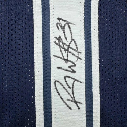 Navy blue and white striped athletic football jersey with black signature on white stripe framed and autographed Roy Williams