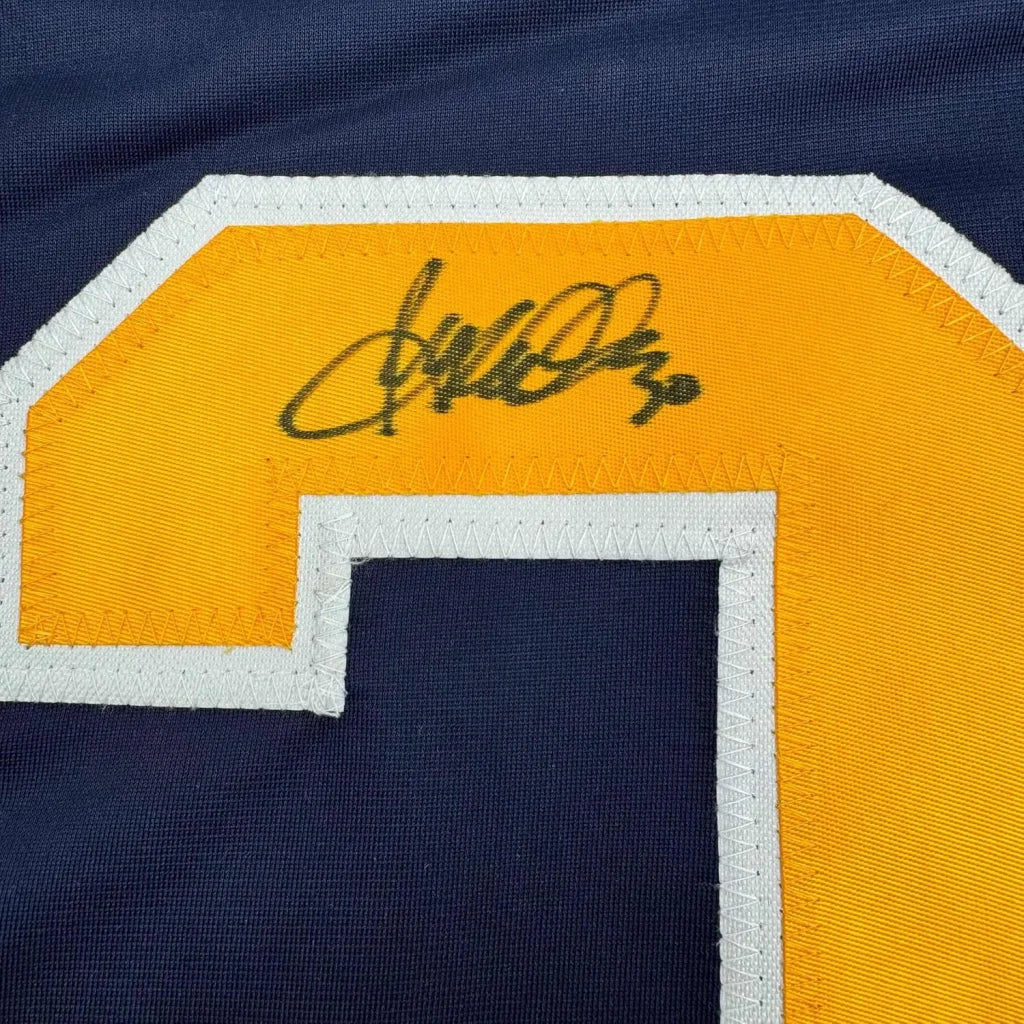 Dark blue buffalo blue hockey jersey with yellow and white number 2 and Ryan Miller autograph