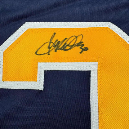 Dark blue buffalo blue hockey jersey with yellow and white number 2 and Ryan Miller autograph