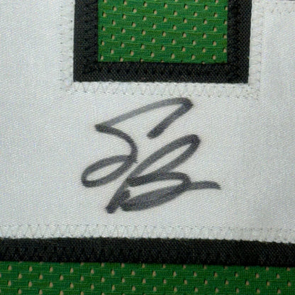 Autographed green and white Saquon Barkley Eagles jersey in a professional frame