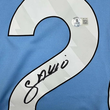 Framed autographed Savinho Manchester City light blue soccer jersey back with number 2, Beckett BAS COA