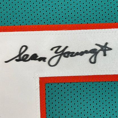 Framed autographed Sean Young Ray Finkle teal Miami Dolphins jersey with Lea Young signature label