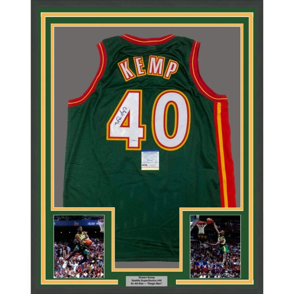Professionally framed Shawn Kemp autographed Sonics jersey with player photos and plaque