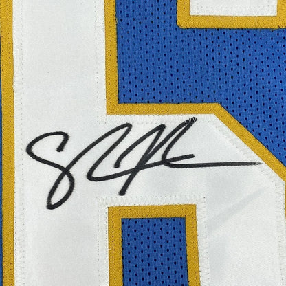 Blue and white Shawne Merriman Chargers jersey with black autograph for your man cave
