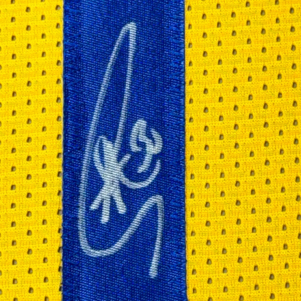 Blue and yellow mesh fabric with white signature on professionally framed Golden State Warriors item