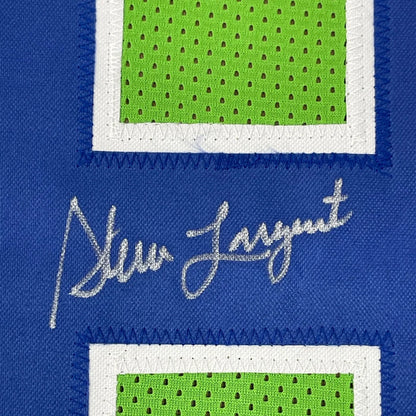Blue sports jersey with green mesh number and white stitching, signed in silver, ready to hang