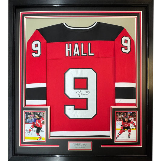 Professionally framed Taylor Hall red hockey jersey with autographed player cards