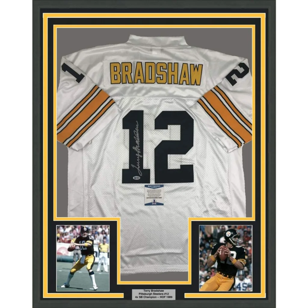 Back side of a framed autographed white pittsburgh steelers football jersey with black and gold bradshaw 12 lettering