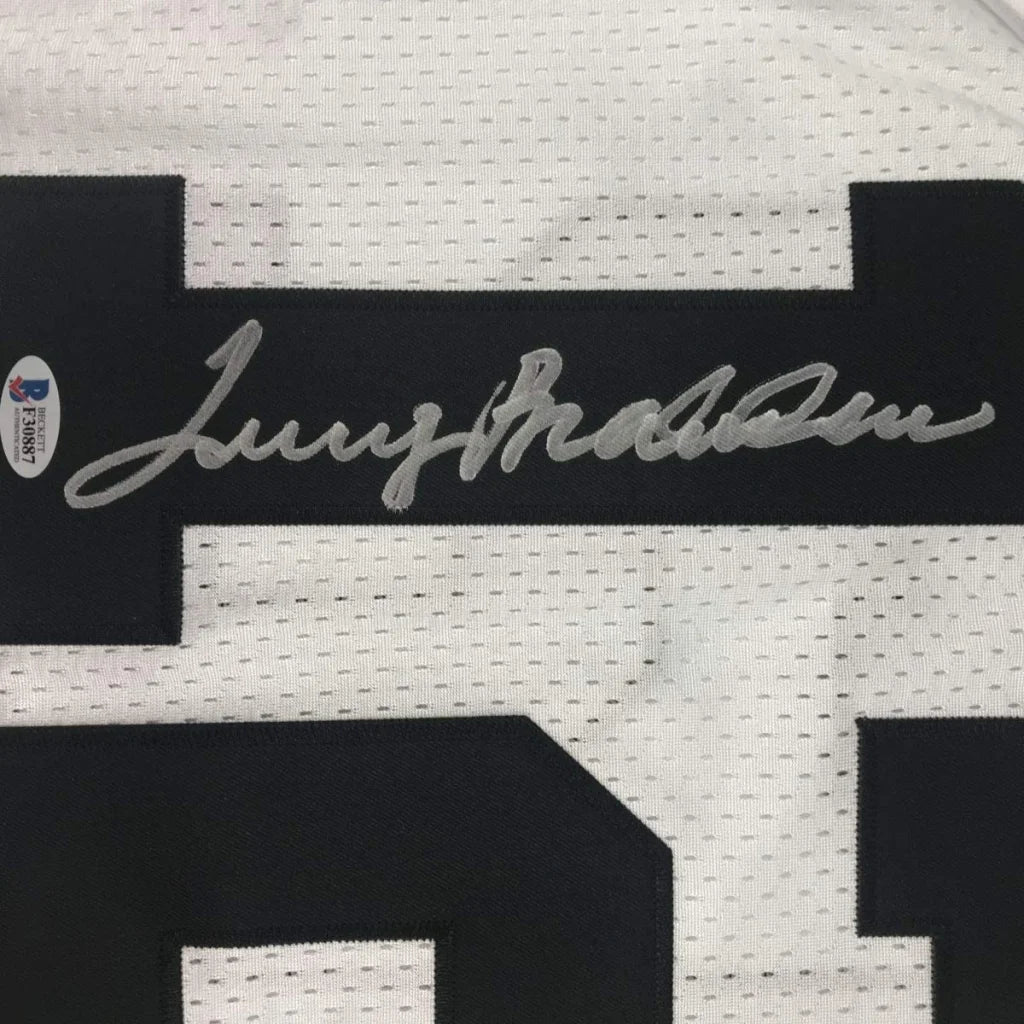 Framed autographed white mesh football jersey with black numerals and silver terry bradshaw signature across the chest