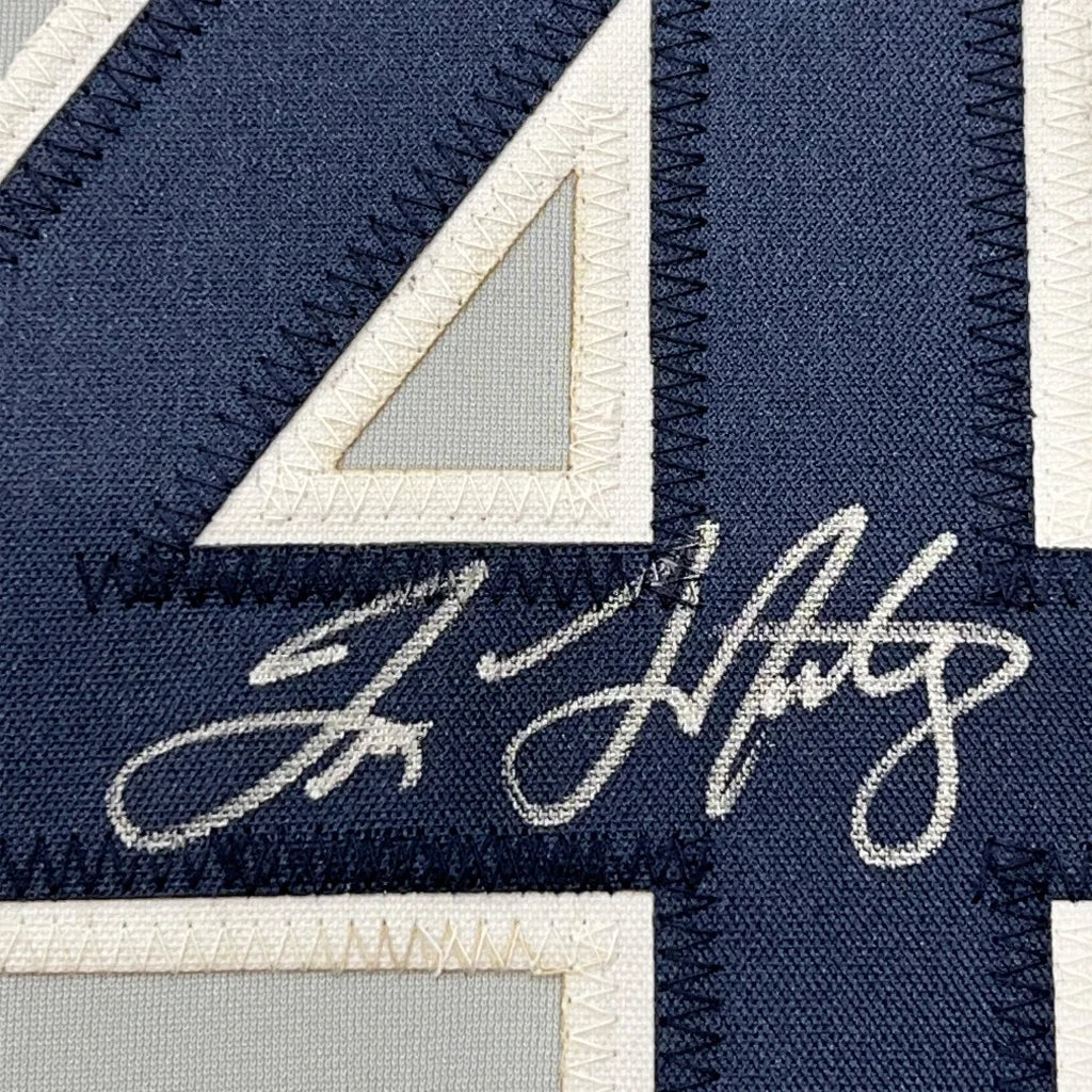 Autographed navy blue Yankees jersey with white number 4 and stitching for wall display