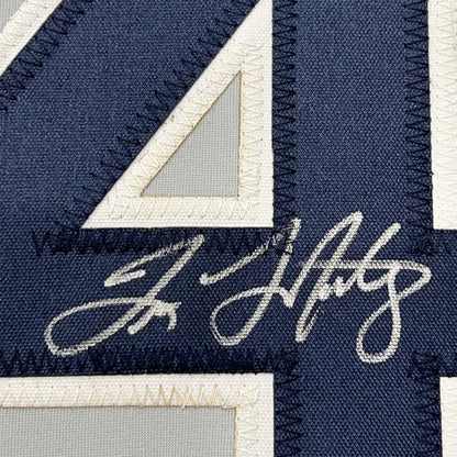 Autographed navy blue Yankees jersey with white number 4 and stitching for wall display