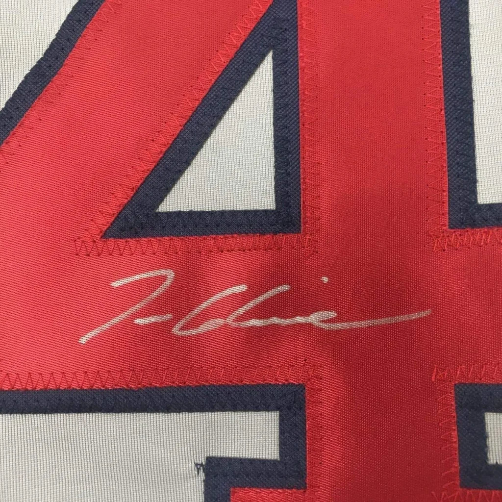 Autographed red and white Braves jersey with number 44 in framed collectible display