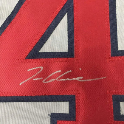 Autographed red and white Braves jersey with number 44 in framed collectible display