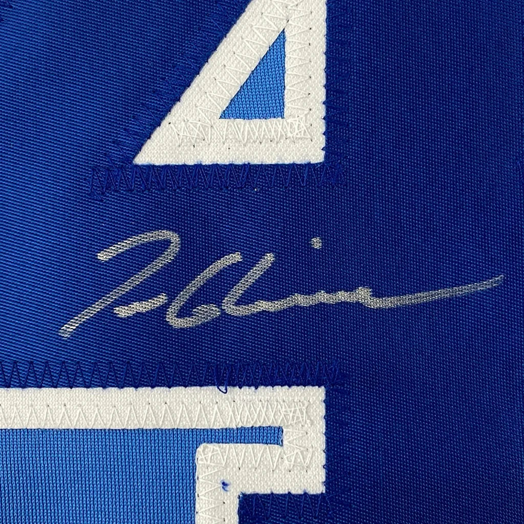 Autographed blue baseball jersey with white numbers ready to display