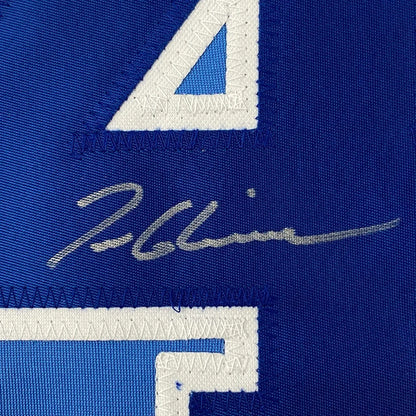 Autographed blue baseball jersey with white numbers ready to display
