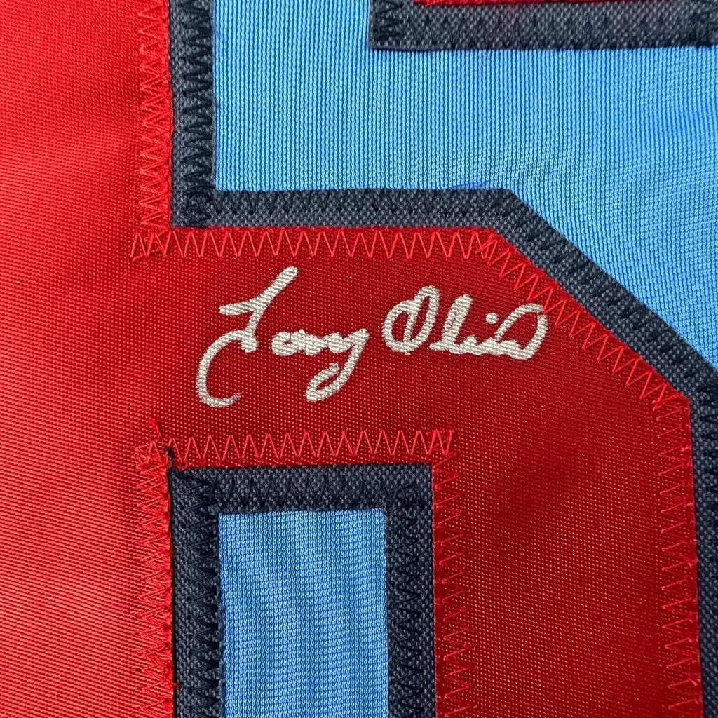 Framed autographed Tony Oliva light blue Minnesota baseball jersey with red and blue patchwork fabric and white embroidered signature, 35x39, Beckett BAS COA