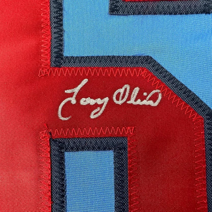 Framed autographed Tony Oliva light blue Minnesota baseball jersey with red and blue patchwork fabric and white embroidered signature, 35x39, Beckett BAS COA
